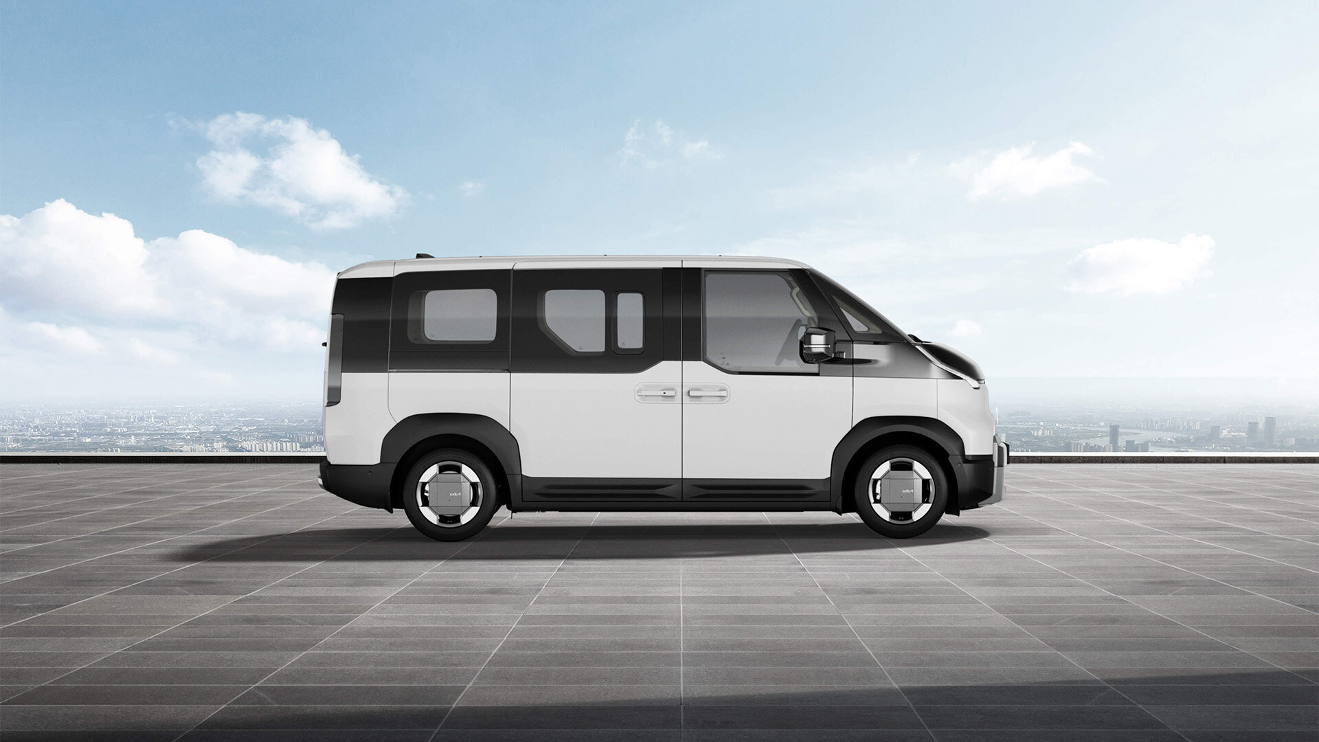 Ein Kia PV5 Passenger in einem strahlenden Clear White, präsentiert von der Wahl-Group, der perfektes Stil und moderne Eleganz in urbanen Umgebungen vereint.